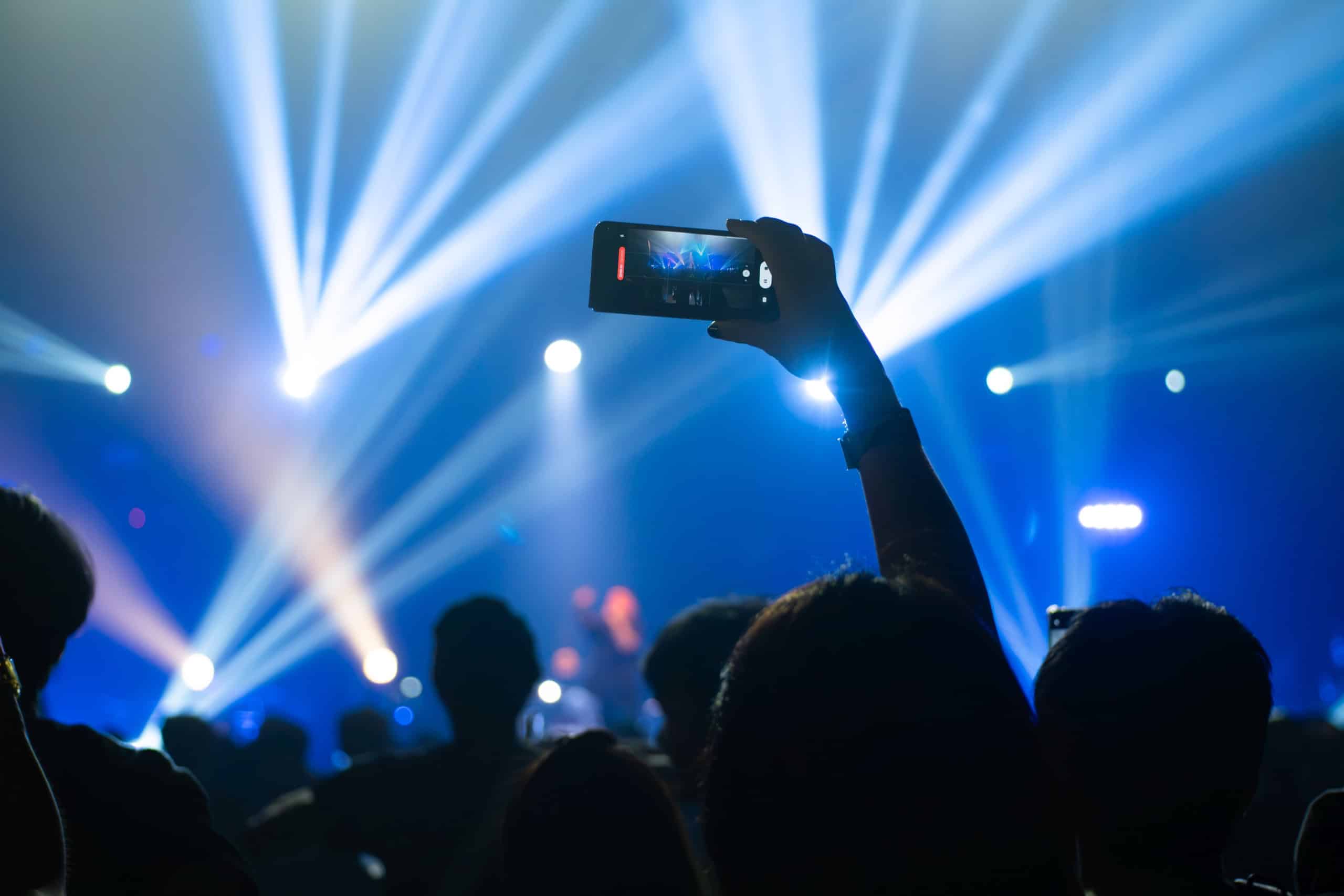 Dancing people watching show with lights in dark nightclub. Concept for nightclub security in Dubai